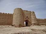 Ruins of buildings near a lake.