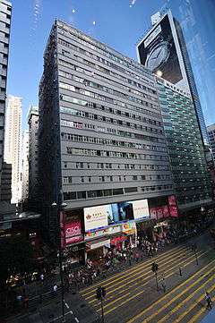 Front elevation of an 17-storey tenement building with street-level retail access