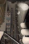 looking down from above at several of the ranks of square wooden and round tapered metal pipes inside the organ.