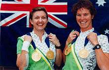 women holding medals