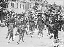 Soldiers marching along a city street