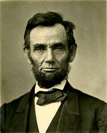 An iconic photograph of a bearded Abraham Lincoln showing his head and shoulders.