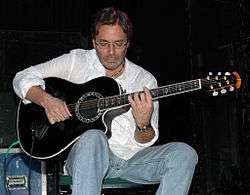 Al Di Meola holds an Ovation guitar