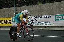 A cyclist riding a bike while in an aerodynamic position.