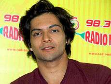 Ali Fazal looking at the camera