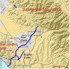 Mountains are to the upper right (northeast) and lower left (southwest), and the flat land in between is highly urbanized.