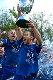 Team Captain Andy Dawson lifts the league trophy at the end of season 2011–12.