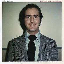 A Polaroid photograph of Kaufman smiling with the title of the album along the upper edge