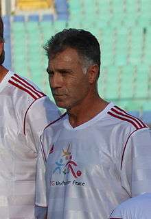 A middle-age man lining up to play association football