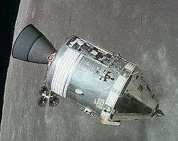 The cone-shaped Command Module, attached to the cylindrical Service Module, orbits the Moon with a panel removed, exposing the Scientific Instrument Module