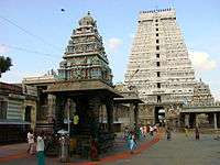 Temple tower with people passing through.