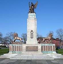 A column flanked by two lions and surmounted by a statue of Peace and a soldier. There are bronze plaques on the base of the monument.