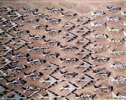 Aerial view of B-52s and other aircraft slowly being scrapped in the desert.