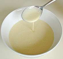 A spoon pouring batter into a bowl