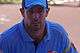 An Australian cricketer wearing blue shirt and cap.