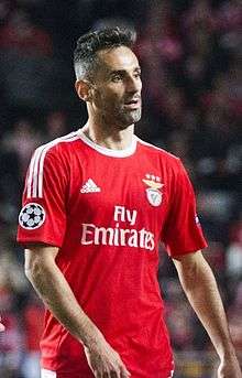 A man with red shirt walking