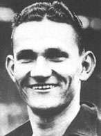 Black-and-white portrait of a smiling man with medium-length hair