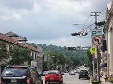 A four lane undivided road in a downtown area