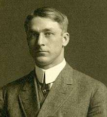 A black-and-white photograph of a man in a suit