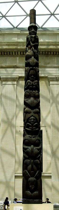 a wood coloured tall totem pole