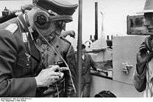 Man in uniform with headphones and throat microphone