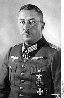 A man wearing a military uniform with an Iron Cross displayed at the front of his uniform collar.