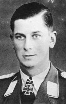 A man wearing a military uniform with an Iron Cross displayed at the front of his uniform collar.