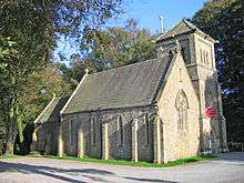 A stone chapel with a small tower surmounted by a pyramidal roof