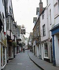 Street scene. Buildings to left and right of narrow road.