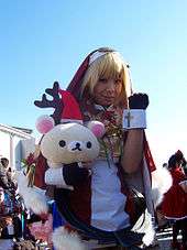 Blond-haired person in nun costume, holding a teddy bear