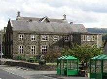 small two-storey building of flint and sandstone