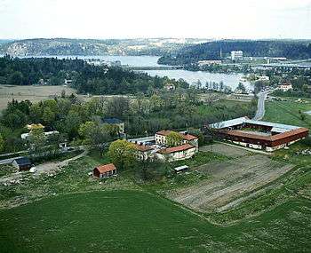 Aerial photo of ring of buildings surrounded by fields