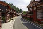 Small street lined by wooden houses.