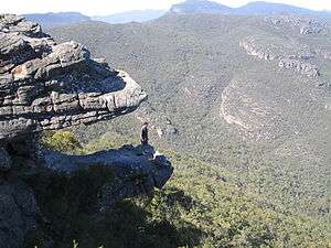 View of the Balconies rock formations including one formerly known as the Jaws of Death since it appears to be an open mouth of two rock slabs with a hiker standing inside