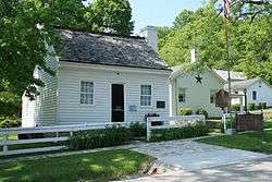 This is a color photo of Grant's birthplace: a small one story wood panel house.