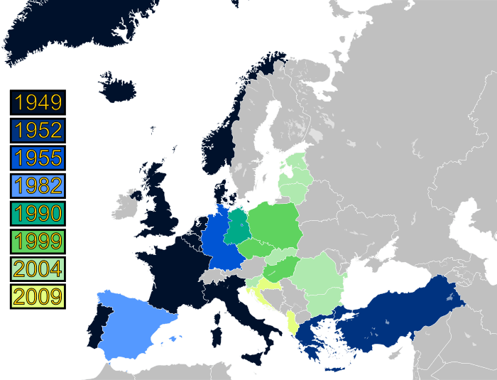 A map of Europe with countries labeled in shades of blue, green, and yellow based on when they joined NATO.