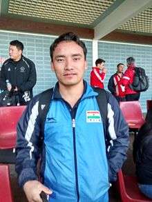 A photograph of a man wearing blue coloured sportswear.