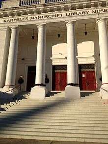 Facade of imposing building with Greek columns.