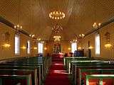 Inside a wooden church, facing the altar.