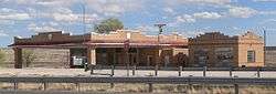 Low brick building with large brick awning