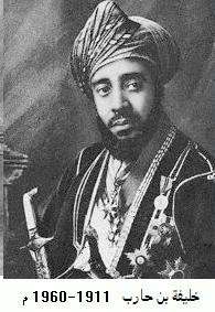 A black-and-white photograph of a man with a dark beard wearing a turban, a dark jacket, a white shirt, and several medals and looking to the right of the viewer