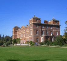 A three-story brick English mansion