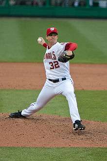 Kip wells in his wind-up, preparing to throw a pitch for the Washington Nationals, wearing uniform number 32.