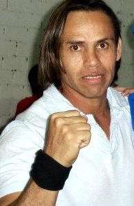 A latino man in a white shirt and black wristbands