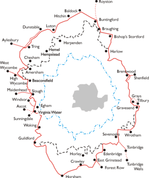 An outline map of the area around London. A series of concentric jagged  lines donate various areas. Outermost is a red ring which is the area within which the LPTB controlled transport services. Within this are a dashed black line (area of monopoly powers), a dashed blue ring (Metropolitan Police District) and a grey shaded area (County of London). The names of towns around the perimeter of the red ring indicate its extent.