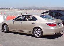 Car backing up with the driver's hands sticking out of the windows.