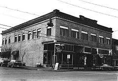 Photograph of the Lumber Exchange Building, a two-story commercial building on a city street corner