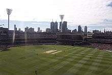 Aerial view of a cricket ground with players occupying the field.