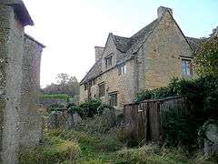 Cotswold stone walls and mullioned windows of Buckland Manor Hotel.