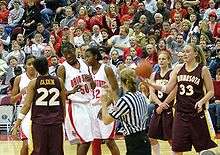 in front of the stands, then team-captain and others discuss a dispute